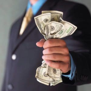 Man's hand holding cash